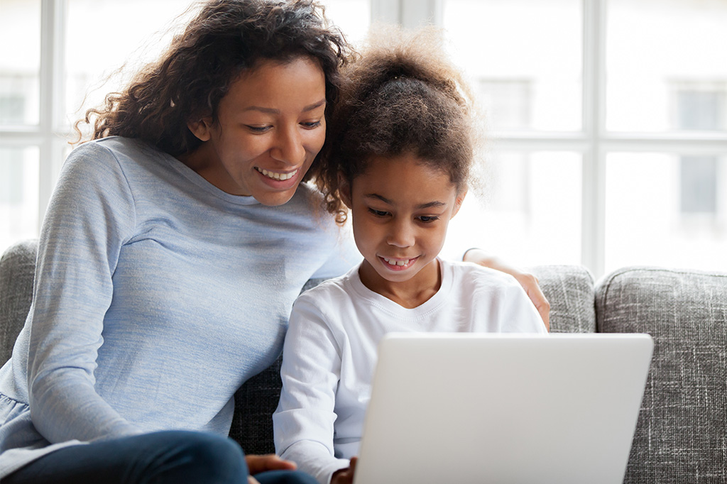 parent and child enjoy learning on computer