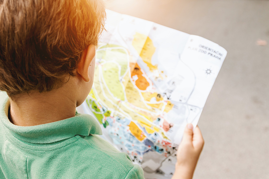 young child reads a map