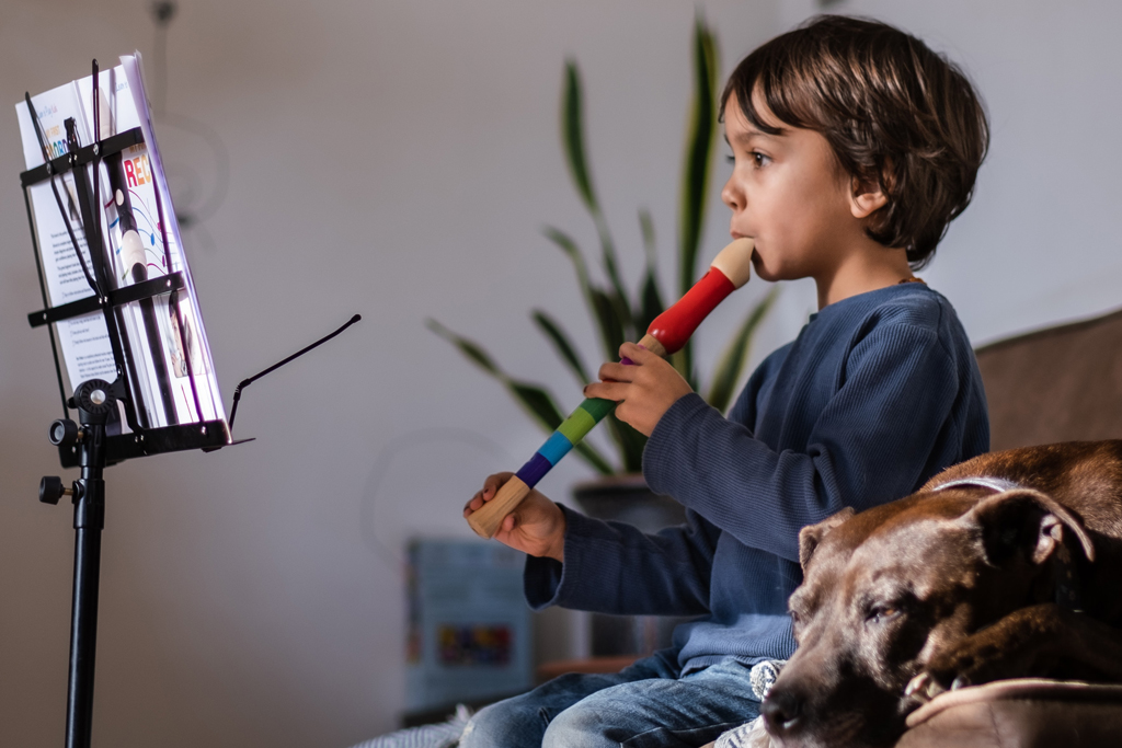 A child playing the recorder at home